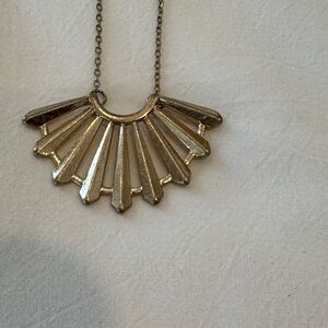 15 1/2” Long fan shape pendant necklace in gold tone.